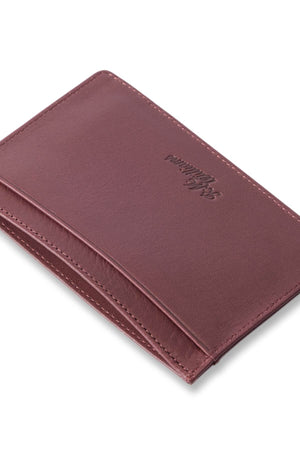 The RM Williams Singleton Vertical Card Holder, handcrafted in Australia from natural milled leather, is showcased against a white background. The wallet, empty and minimalist in design, features clean lines and a smooth texture. The brand's logo is embossed on the front.