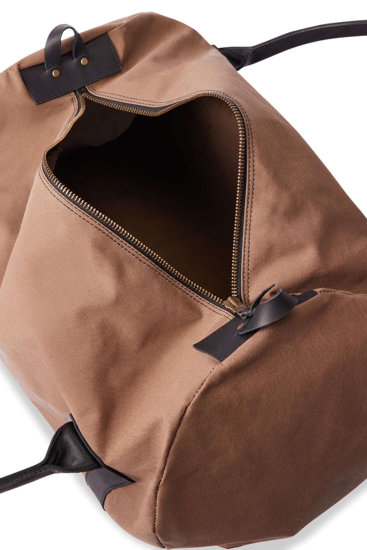 The RM Williams Sorrento Ute Bag is a brown canvas duffel with black handles and leather trims, shown partially unzipped to reveal its spacious, empty interior.