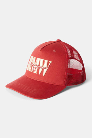 RM Williams Steers Head Trucker Cap in red, designed with a breathable mesh back and featuring an embroidered white "R A W" logo on the front along with a small steer skull illustration at the center.
