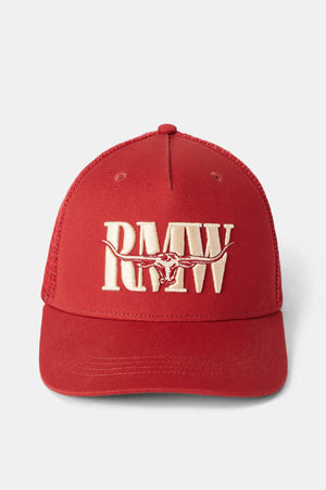The RM Williams Steers Head Trucker Cap features a red color with a breathable mesh back, showcasing embroidered "RMW" letters and a cream-colored longhorn cattle skull design on the front.
