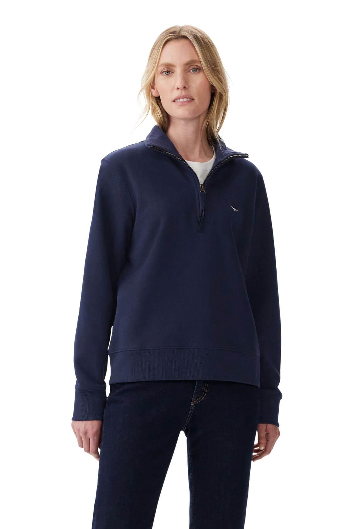 A blonde woman is wearing the RM Williams Trickett Zip Neck Sweatshirt in navy blue Cotton Terry and dark jeans, standing against a plain white background.