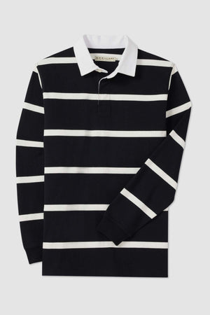 The RM Williams Tweedale Rugby shirt is a black, long-sleeve rugby shirt showcasing white horizontal stripes and a white collar, crafted from heavyweight knit material. One sleeve is partially folded over the torso of the shirt.