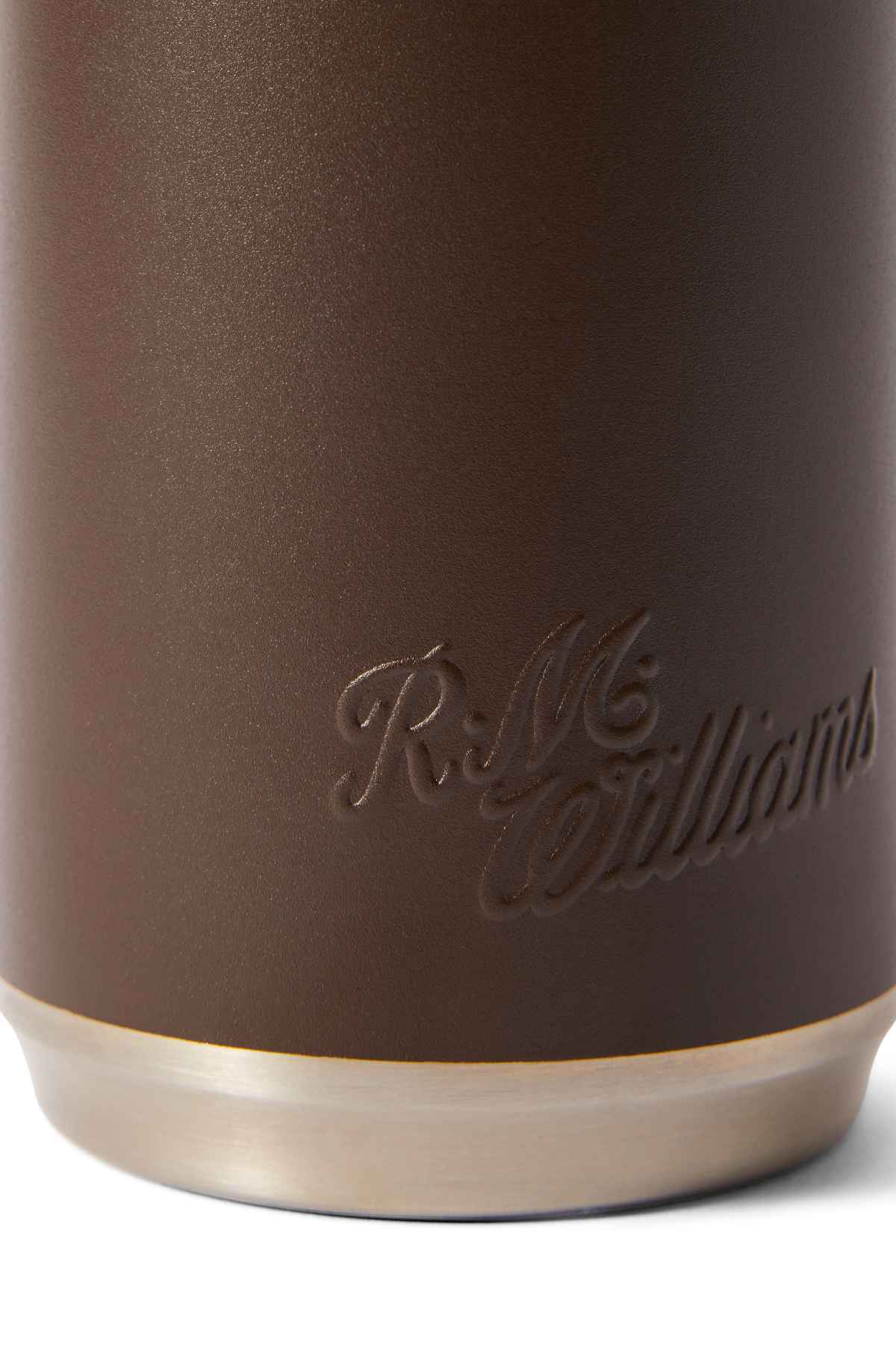 Close-up of the RM Williams Vacuum Flask with a brown textured surface, embossed cursive "R.M. Williams," and a lighter, metallic edge inspired by stainless steel design.
