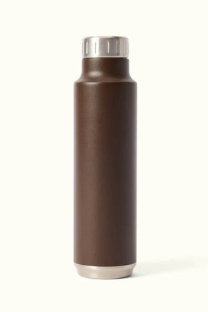 The RM Williams Water Bottle, a sleek, brown BPA-free stainless steel design with vacuum insulation and a silver cap, stands upright against a plain beige background.
