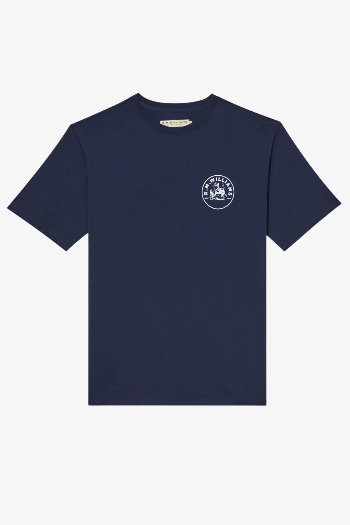 The RM Williams Wondai T-Shirt is a plain navy blue, short-sleeved cotton jersey with a small white archive-inspired circular graphic and text on the left chest. It is shown laid flat on a white background.