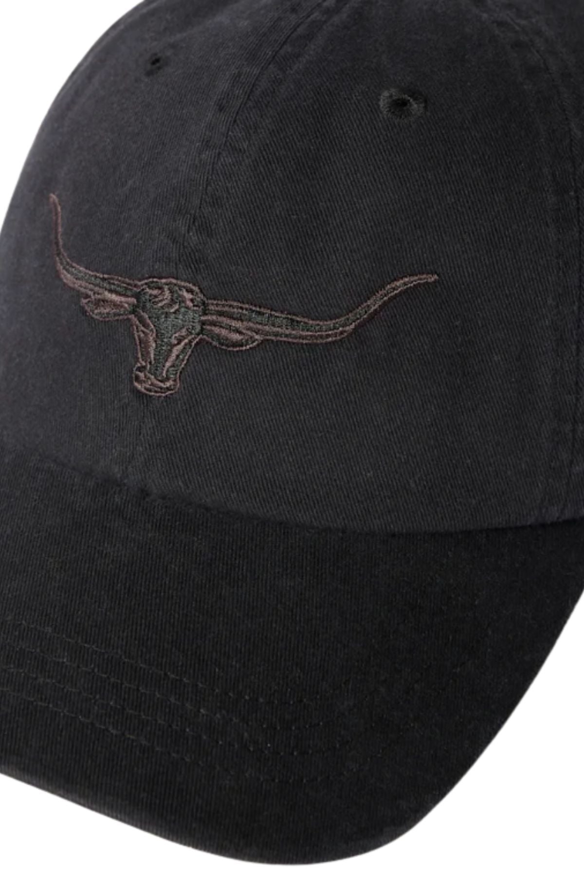 The RM Williams Longhorn Twill Cap is a black organic cotton cap featuring an embroidered Longhorn outline on the front and an adjustable strap for comfort.