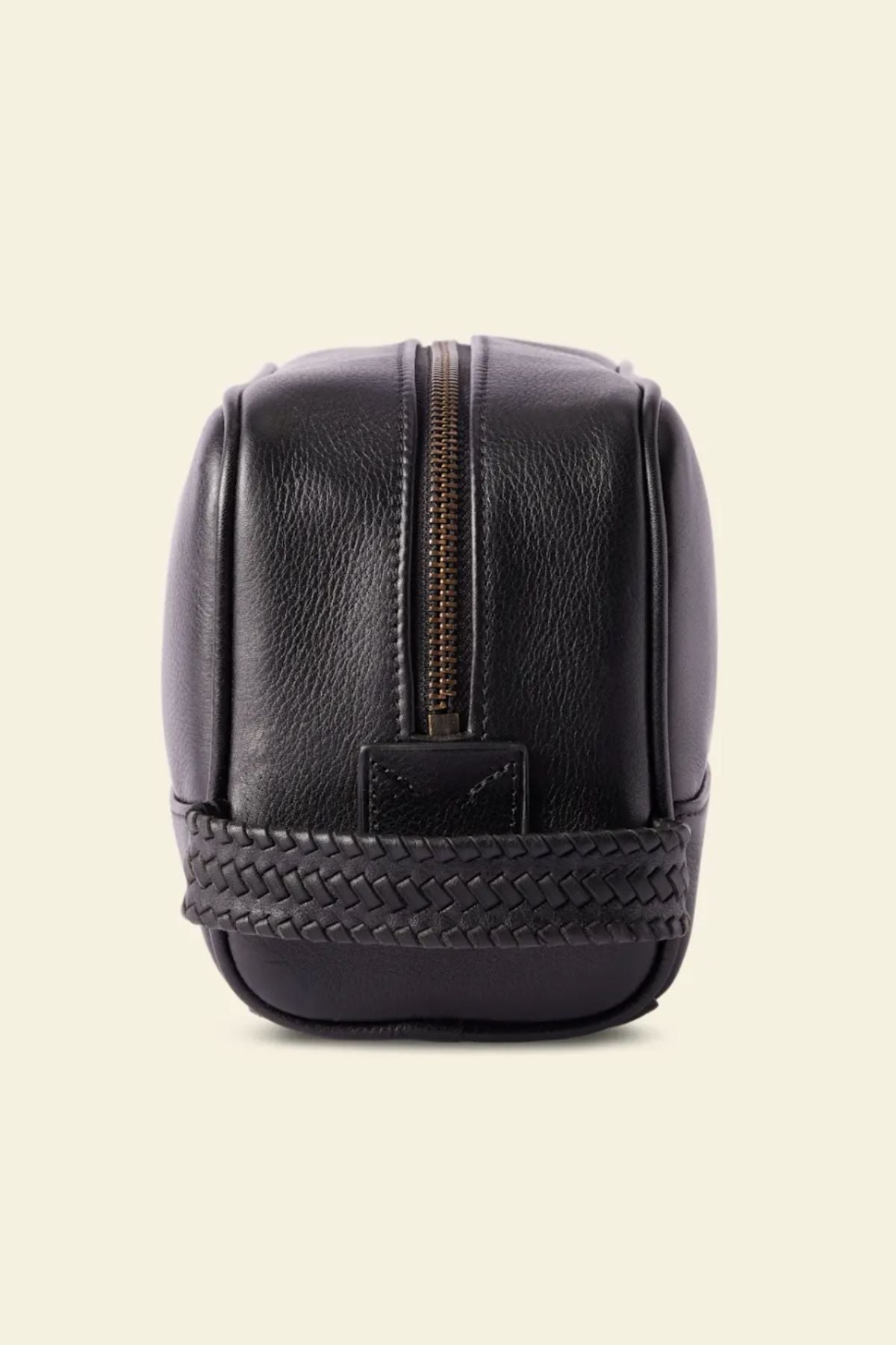 The RM Williams Farrier Signature Washbag, crafted from black tumbled grain leather with a woven base detail, is shown upright against a light background—perfect for use as a travel toiletry bag.