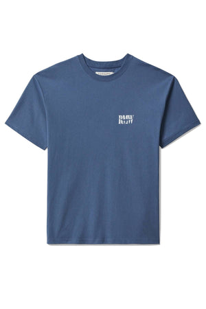 The RM Williams Branded T-Shirt is a plain blue relaxed fit tee in soft organic cotton jersey, featuring a small white βRAWβ heritage logo on the left chest, shown against a white background.