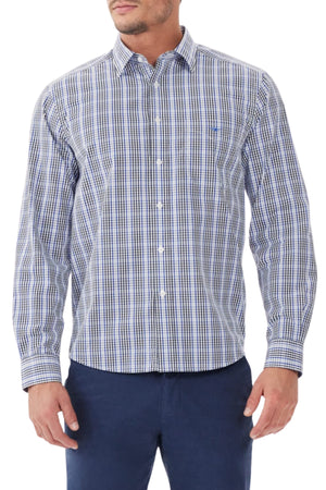 A man is wearing the RM Williams Collins Shirt, a twill cotton button-down with a blue, white, and black checkered pattern and subtle Longhorn embroidery on the chest pocket. He pairs it with dark blue pants. The head is not visible.