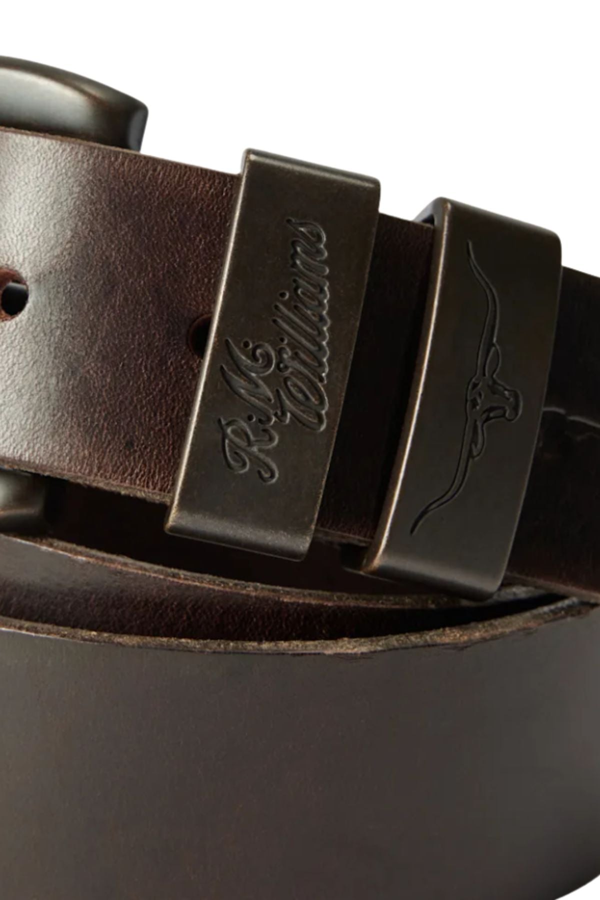 Close-up of the RM Williams Drover Belt, crafted in Australia from premium vegetable-tanned leather. Features a sturdy metal buckle engraved with "RM Williams" and an embossed longhorn logo.