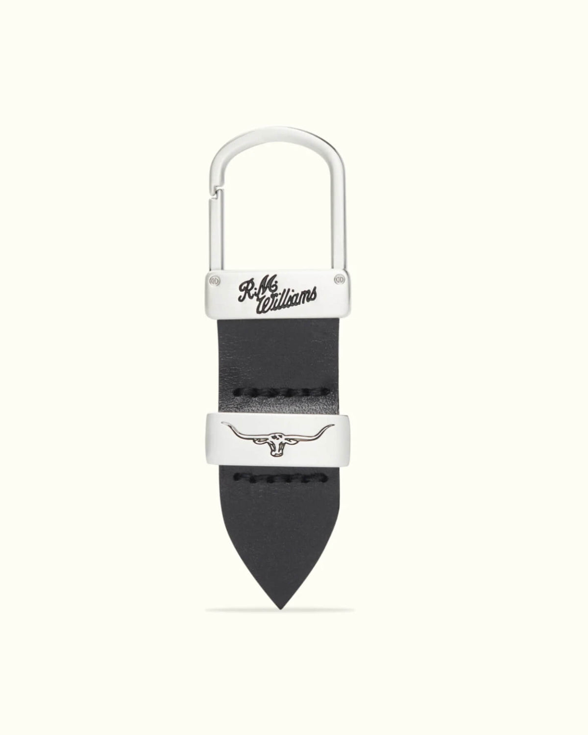 The RM Williams Drover Key Fob includes a black double butt leather keyring, silver metal clasp and hook, with "R.M. Williams" engraved on the clasp and a silver-colored longhorn emblem on the leather.