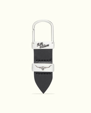 The RM Williams Drover Key Fob includes a black double butt leather keyring, silver metal clasp and hook, with "R.M. Williams" engraved on the clasp and a silver-colored longhorn emblem on the leather.