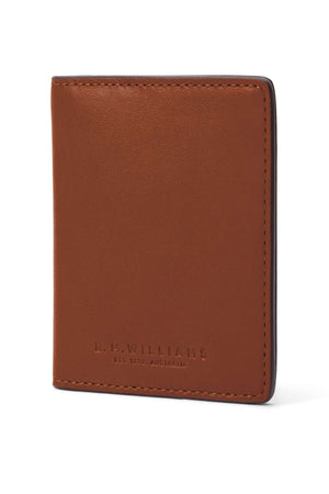 A brown RM Williams Farrier Fold Cardholder stands upright, showing embossed "R.M. WILLIAMS EST. 1932 AUSTRALIA." text. It features clean stitching and multiple card slots for a simple, classic look.