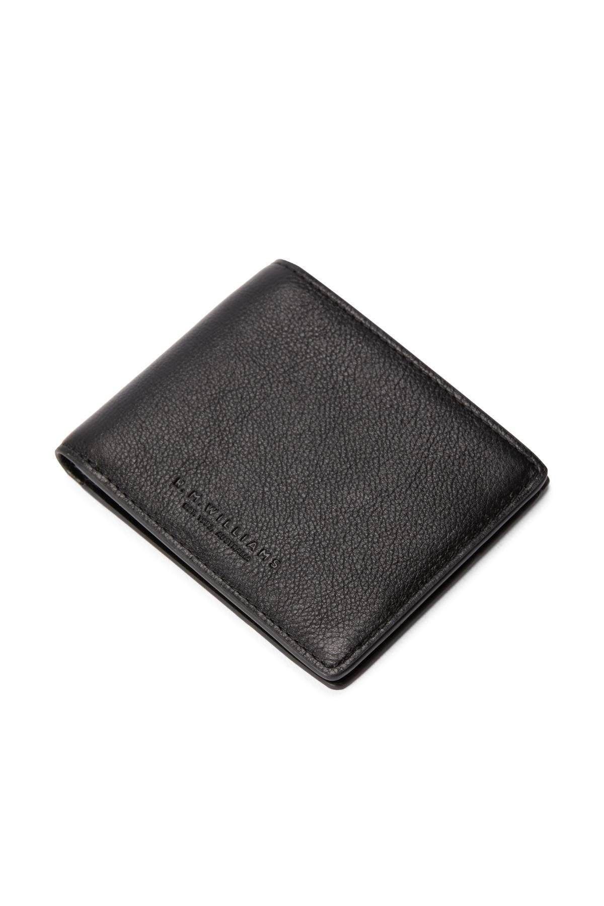 The RM Williams Farrier Slim Bi Fold Wallet in black leather features a textured finish, subtle embossed branding, and multiple card slots. It is shown partially closed on a white background.