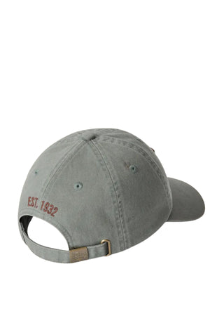 The RM Williams Heritage Twill Cap is shown from the back in faded green, with "EST. 1933" embroidered in red above the opening and an adjustable metal strap for a custom fit.