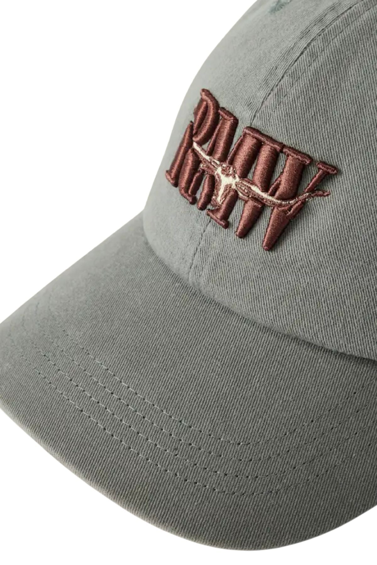 A close-up of the RM Williams Heritage Twill Cap in gray, featuring brown embroidered text and a barbed wire design on the front.