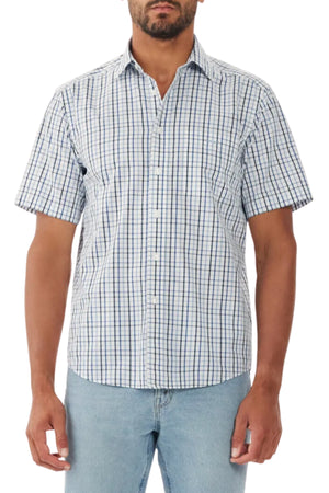 A man wears the RM Williams Hervey Shirt, a short-sleeve, button-up with blue and white plaid in breathable cotton, paired with light blue jeans, standing against a white background.
