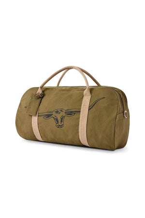 The RM Williams Nanga Canvas Bag is an olive green, durable cotton duffel with beige handles and straps, a bold black longhorn skull outline on the side, and a small pocket with a tag near the handles.