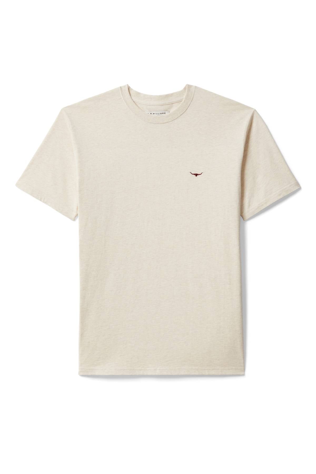 The RM Williams Parson T-Shirt is a plain beige short-sleeve tee with a ribbed crew neck and a small dark red Longhorn embroidery on the left chest, featuring no other visible patterns or designs.