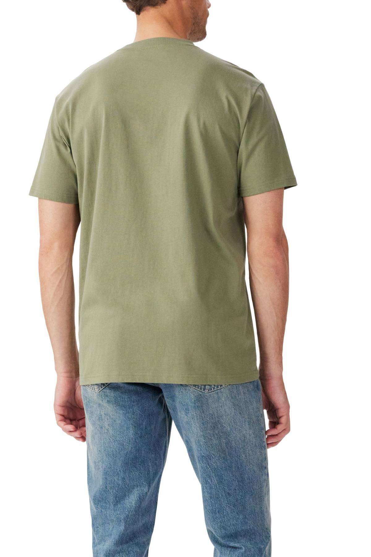 A man faces away from the camera, wearing the RM Williams Prospect T-Shirt in olive green with a ribbed crew neck and branded print, paired with light blue jeans. He stands against a plain white background.