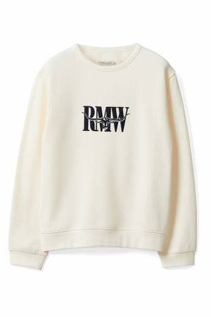 The RM Williams Retro Logo Sweatshirt is a cream, relaxed-fit top with long sleeves and ribbed cuffs, featuring a bold black "RMW" Heritage logo on the chest and a small cowboy riding a bucking horse inside the logo.