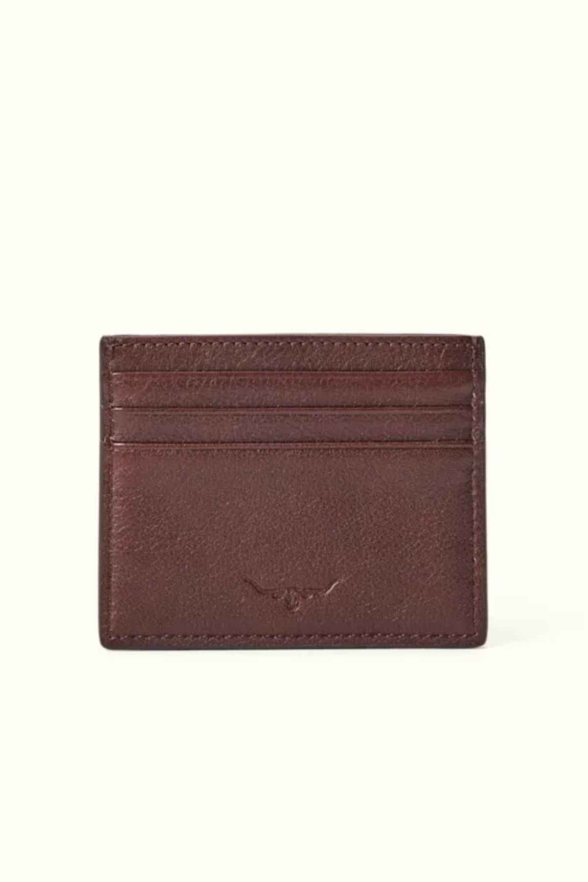 The RM Williams Farrier Card Holder is a brown card holder made from premium leather, featuring multiple horizontal card slots, subtle stitching, and an embossed logo at the center.