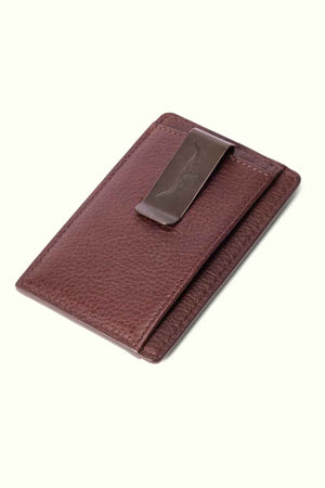 The RM Williams Farrier Cardholder with Money Clip is a premium leather accessory featuring a sleek metal money clip and an embossed feather design. The closed brown cardholder rests elegantly against a neutral background.