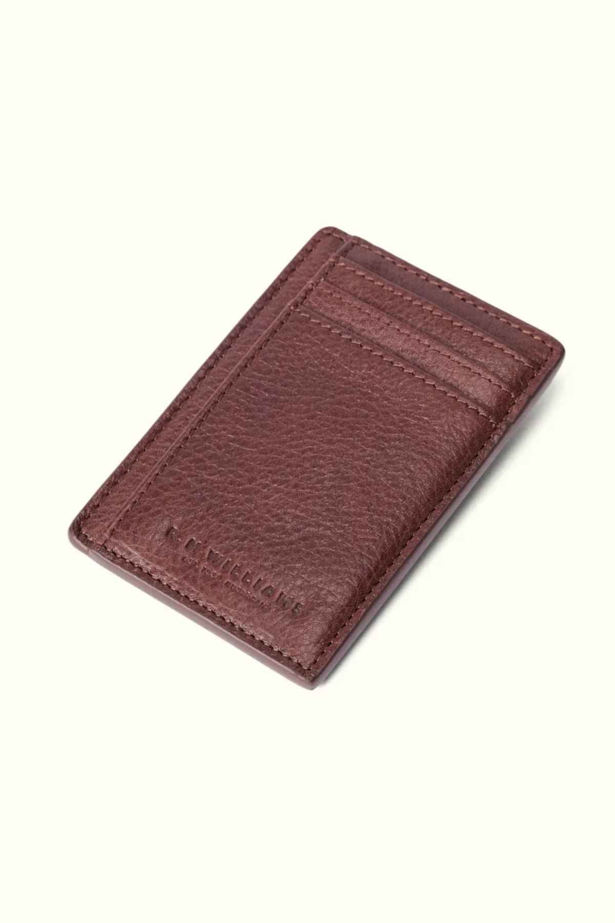 The RM Williams Farrier Cardholder with Money Clip is a premium leather accessory featuring a textured brown surface, multiple card slots, and subtle embossed text at the bottom.