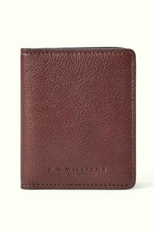 The RM Williams Farrier Fold Cardholder, crafted from premium brown leather and embossed with "R.M. Williams" and "Est. 1932 Australia" on the front, features a textured appearance against a light background. It provides ample card slots for optimal organization.