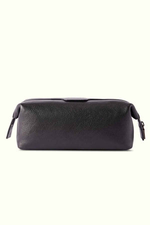 The RM Williams Farrier Washbag is crafted from dark leather with a textured finish. It features a frog-mouth zipper and two zipper pulls on each end. Its rectangular design makes it ideal for storing toiletries or small items, offering a blend of style and functionality.