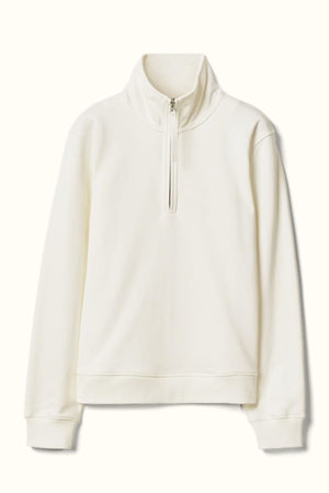 The RM Williams Trickett Zip Neck Sweatshirt is a plain, long-sleeve off-white pullover made from organic cotton, featuring a high collar and a front quarter zip closure, shown against a light background.