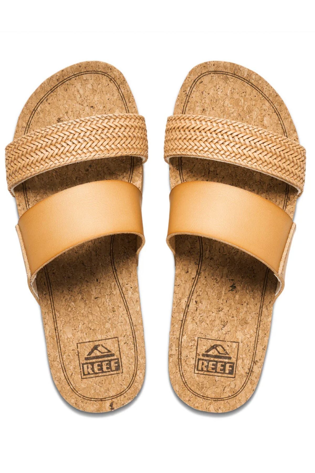 The REEF Cushion Vista Hi TX are tan slide sandals with a cork footbed, cushioned midsole, and two straps—one woven, one smooth. The "Reef" brand and logo are printed on the footbeds.