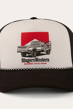 The Ringers Western Bout A Truck Trucker is a stylish black and white breathable cap featuring a pickup truck graphic on a red square and the words "Ringers Western Somethin’ ‘bout a truck" on the front.