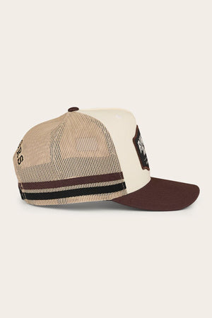 The Ringers Western Country Club Deep Fit Trucker Cap features a beige and brown design with a mesh back, solid front panel, brown visor, rectangular front patch, black and brown side stripes, and an adjustable snapback for comfort.