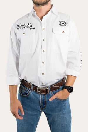 A man wears the Ringers Western Hawkeye Embroidered Shirt in premium cotton with logo and branding on the chest, paired with blue jeans, a brown belt, and a wristwatch. His left hand is in his pocket; his face is not visible.
