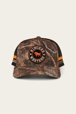 The Ringers Western McCoy Trucker Cap is a cotton twill camouflage design featuring "Ringers Western" text and animal logo on the front, with a breathable mesh back, vibrant orange side stripes, and a plain backdrop enhancing its rugged style.