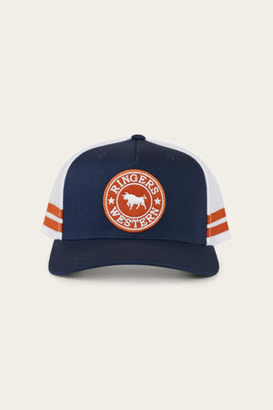 The Ringers Western McCoy Trucker Cap is a navy-blue and white hat featuring a circular orange cotton twill patch with a cow and the words "Ringer's Western" on the front, along with orange double stripes on both sides.