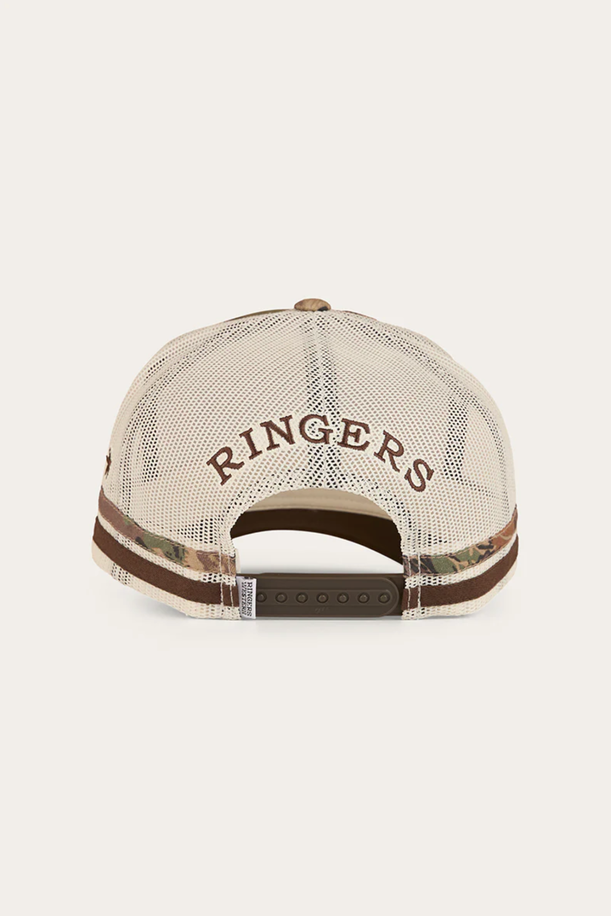 The Ringers Western Shooter Deep Fit Trucker Cap’s back features a beige mesh panel, brown "RINGERS" embroidery above the adjustable snapback, and a patterned strip along the bottom edge.