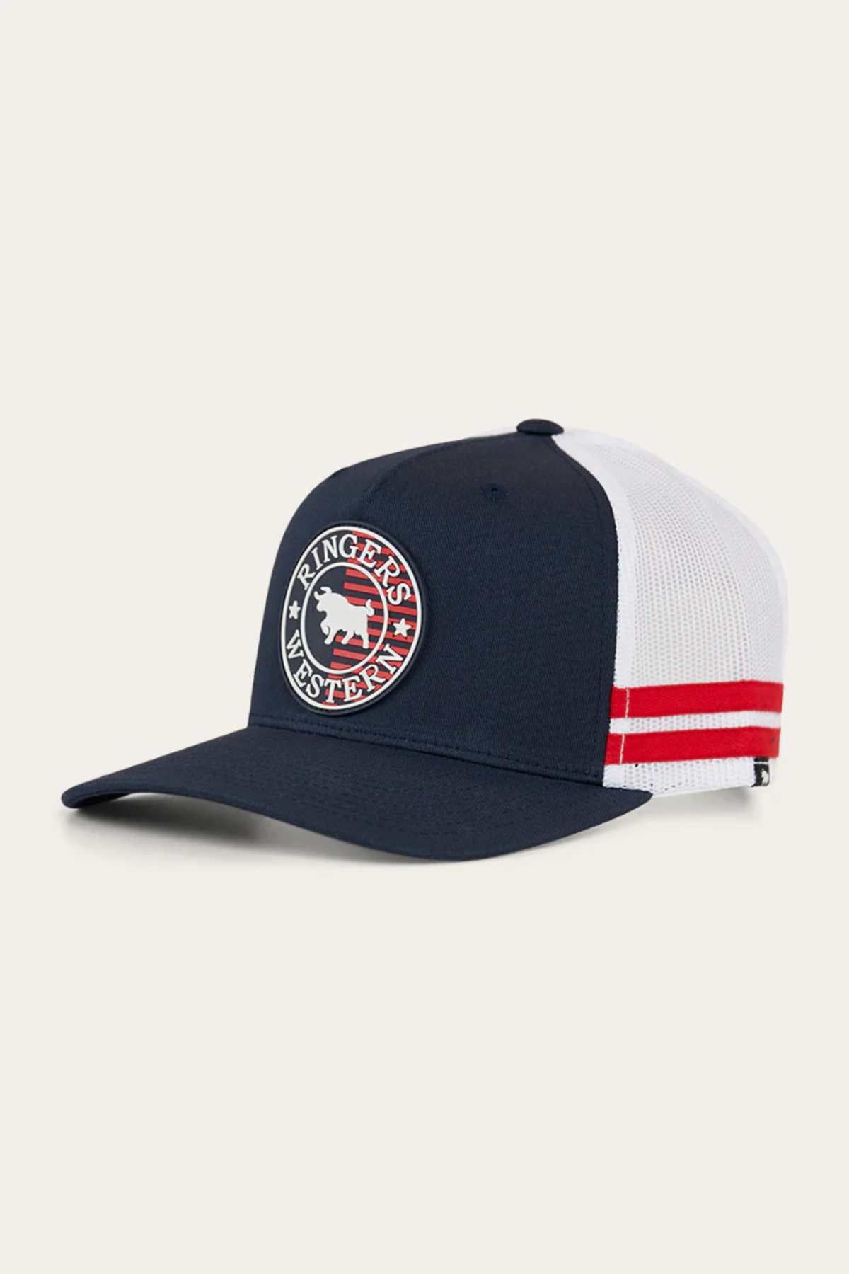 The Ringers Western Signature Bull Flag Trucker Cap is navy blue and white with red side stripes, a circular patch with a white bison and "Ringers Western," plus an adjustable snapback closure for comfort.