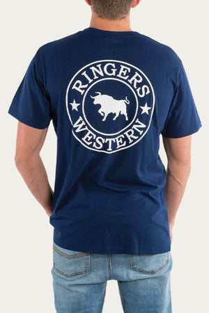 A person in a Ringers Western Signature Bull Loose Fit T-Shirt, crafted from cotton jersey and featuring a bull graphic in navy blue, stands with their back to the camera. Paired with light blue jeans, it creates a laid-back look.