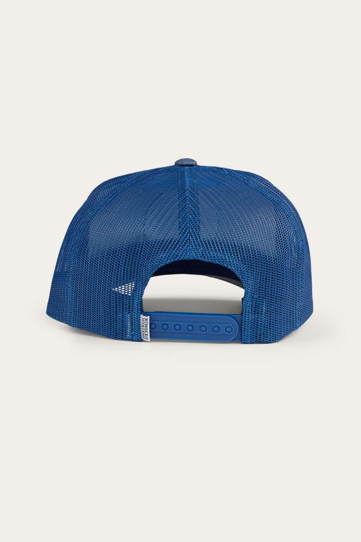 The Ringers Western Signature Bull Trucker Cap, seen from behind, showcases a bright blue mesh design with a snapback closure. It features a curved bill and an adjustable strap that includes a small white tag.