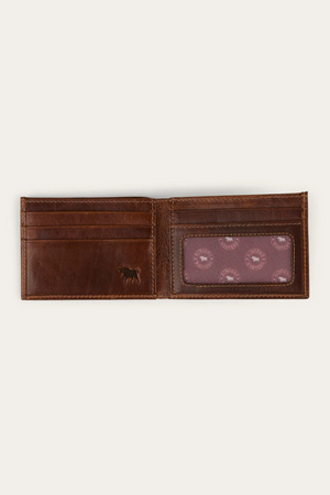 The Ringers Western Toro Slim Wallet features card slots on the left and a transparent ID window on the right, with a subtle embossed animal logo below—crafted from full grain leather for timeless appeal in a slim design.
