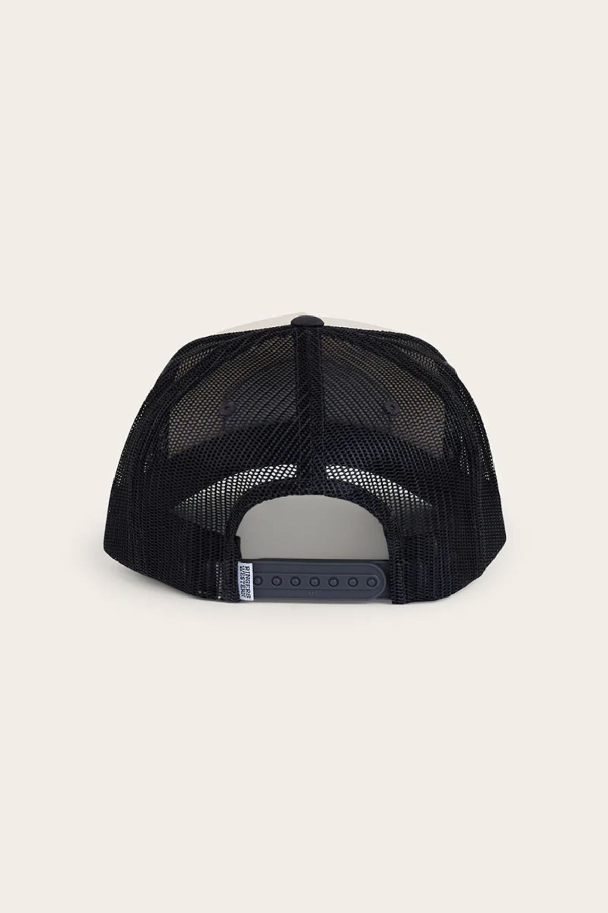The Ringers Western Wheatbelt Trucker Cap in black is shown from the rear, highlighting its breathable mesh back, adjustable plastic snap closure, and a small left side tag against a plain light background.
