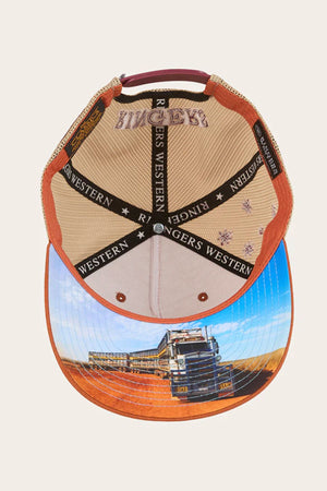 The Ringers Western Workhorse Trucker Cap is shown upside down, revealing the inner lining with "RINGERS WESTERN" text. Its brim features a truck on a dirt road in a rural landscape, combining classic trucker style and sun protection.