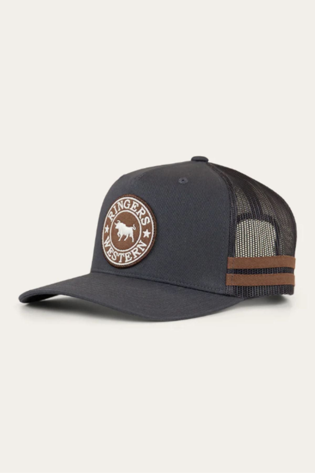 The Ringers Western McCoy Trucker Cap is black with a brown circular "Ringers Western" patch and bull logo, mesh back, snap-back closure, and two brown side stripes.