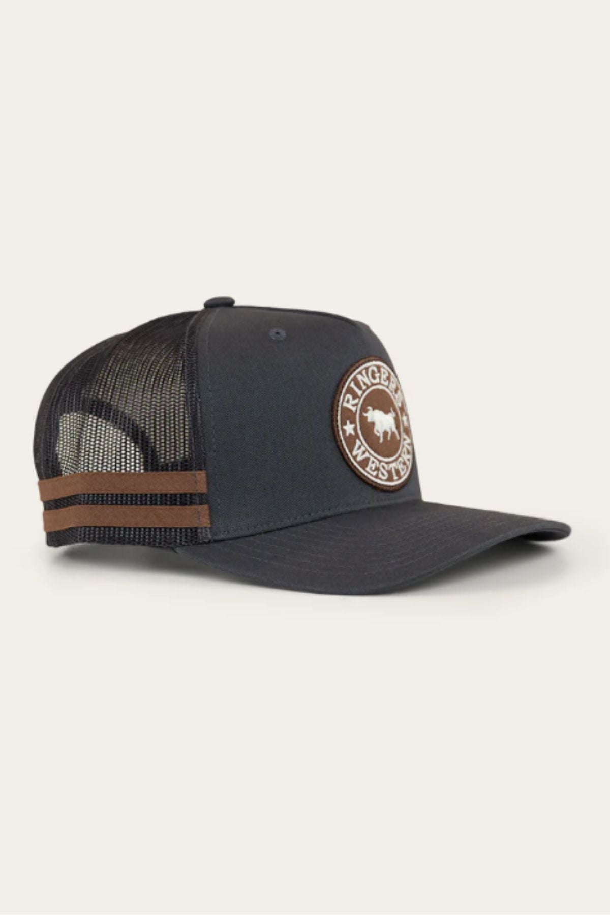 The Ringers Western McCoy Trucker Cap is a black mesh cap with a curved brim, brown side stripes, and a front patch showing a buffalo and “Ringers Western.” It has a snap-back closure for an adjustable fit.