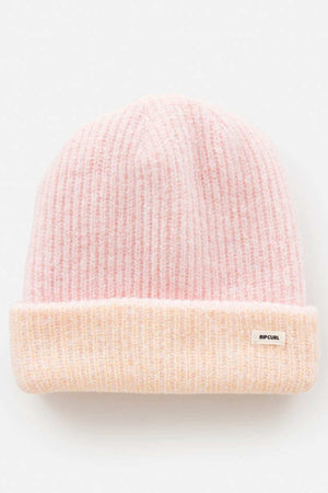 A soft, pink knit Rip Curl 2 Tone Reg Revo Beanie with a ribbed texture. This tall beanie has a folded brim featuring a small label on a plain white background.