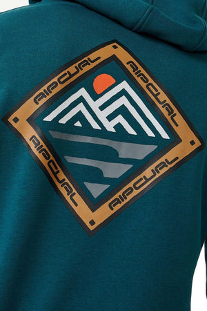 The image displays the back of a teal Rip Curl Anti Series Journey Hood, featuring a diamond-shaped abstract mountain design and sun. A brown border with "AIPCUAL" repeatedly adds style, while thumb holes enhance its functionality.