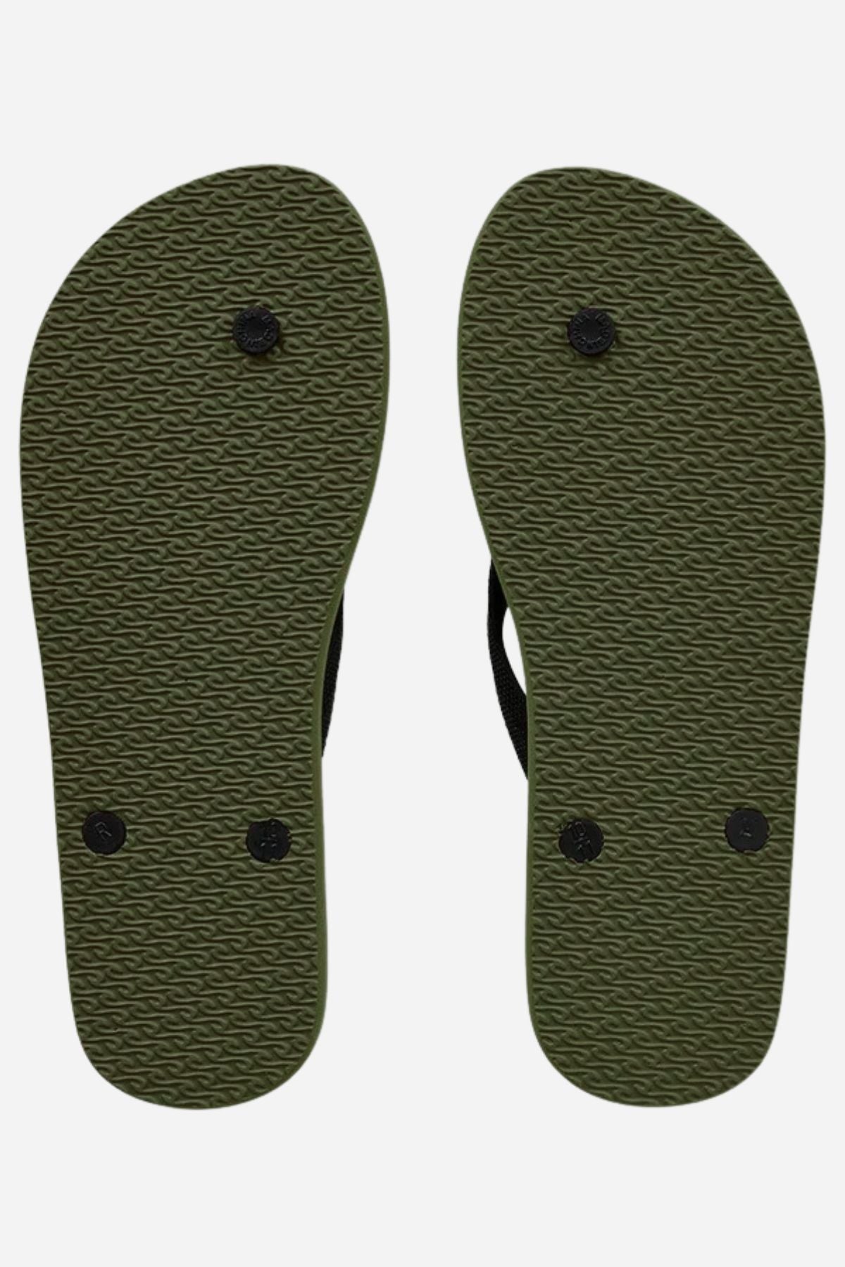 The image shows the soles of two Rip Curl Brand Logo Bloom Thongs, side by side. Made with BLOOM™ algae foam, they feature a textured pattern and four black circular plugs each, set against a plain white background.