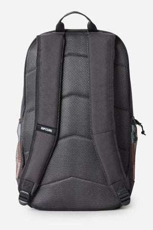 Back view of the Rip Curl Chaser 33L Backpack in black recycled polyester, featuring padded shoulder straps and back panel with mesh details, a small Rip Curl logo on one strap, side pockets, zippers, and 15" laptop compatibility.